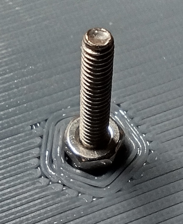 Nut Threaded On and In Contact With Pocket