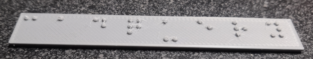 Printed label with defects including stringing
