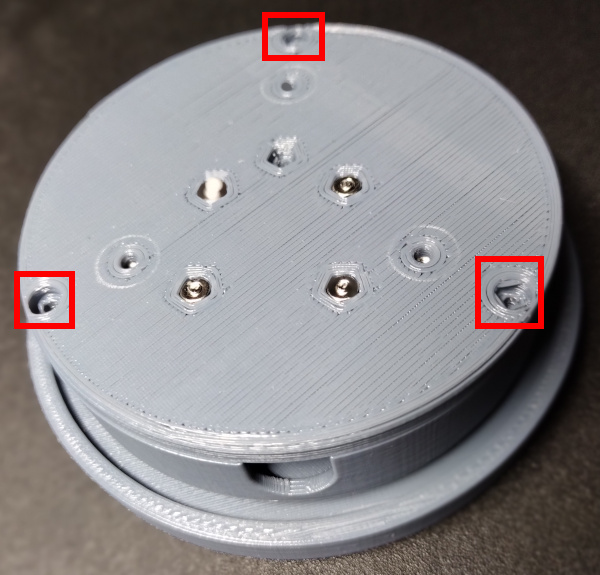 Bottom placed on assembled body with mounting holes shown